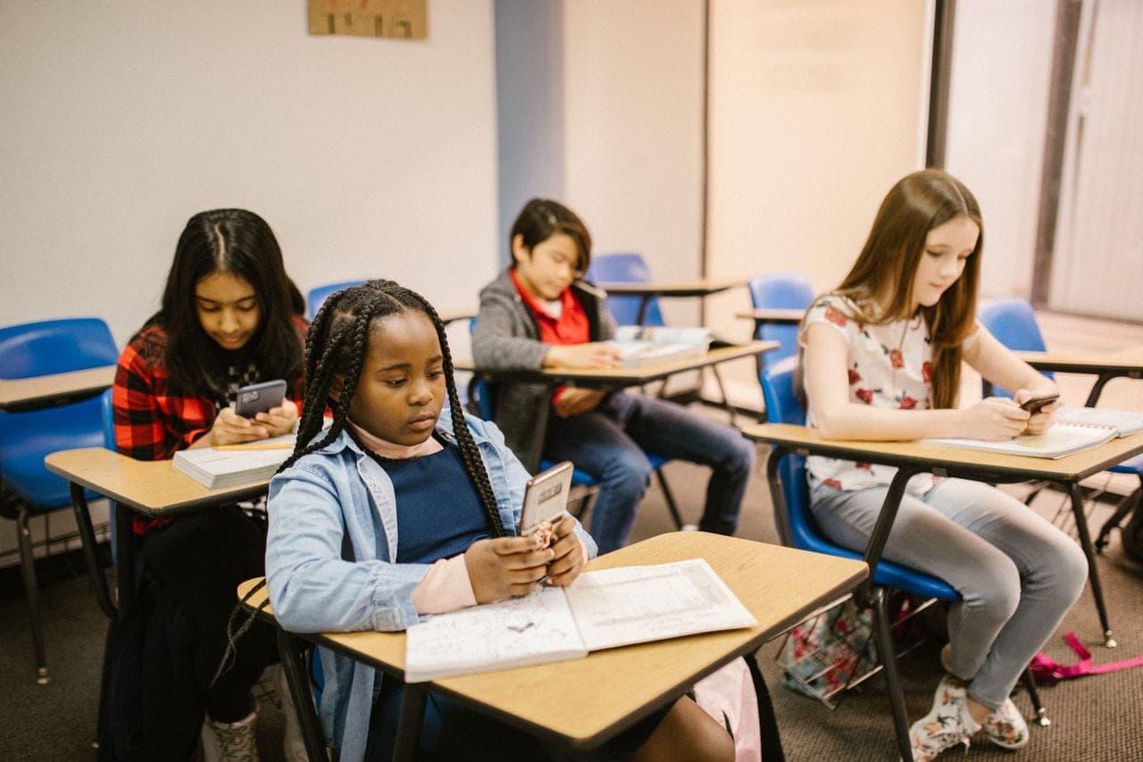 Pupils work at desks in a bright classroom