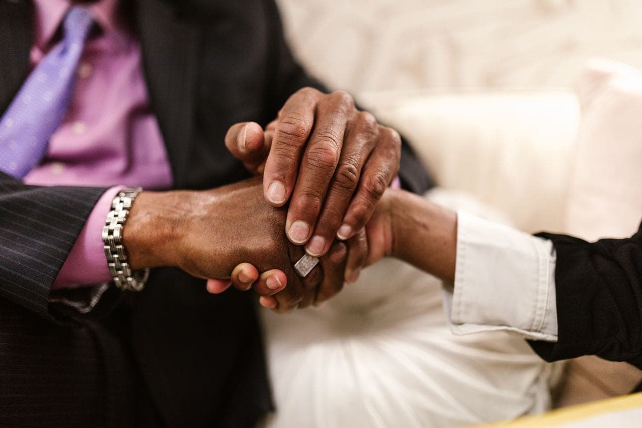 Two people shake hands across a table